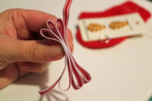 fold ribbon to make bow for mitten ornament