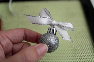 tie a bow on the ornament