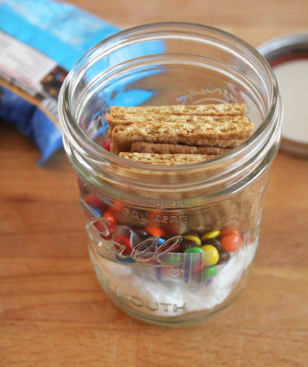 Put crackers and candy in jar