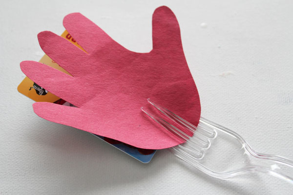 put hand and card on fork