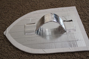 tape handle to back of shield
