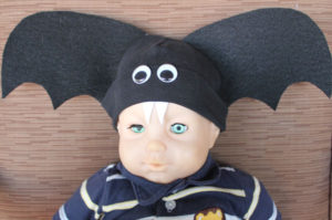 creepy doll wearing bat hat