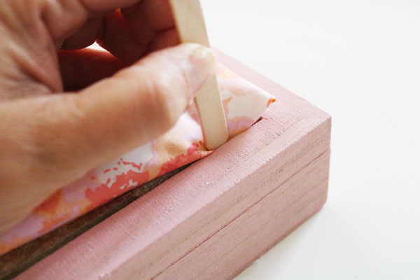 use popsicle stick to tuck in fabric