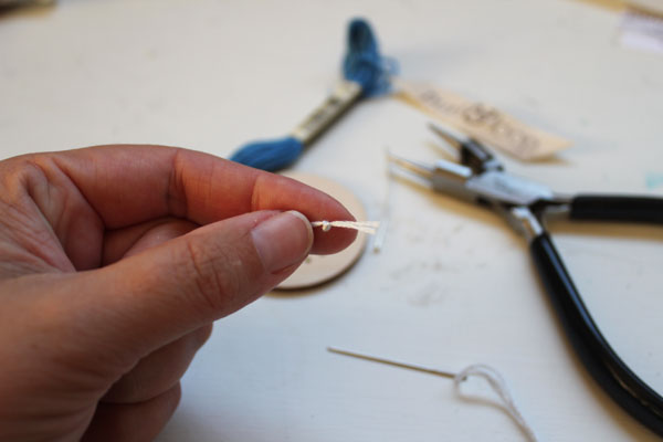 tie a knot to start the woven ornament